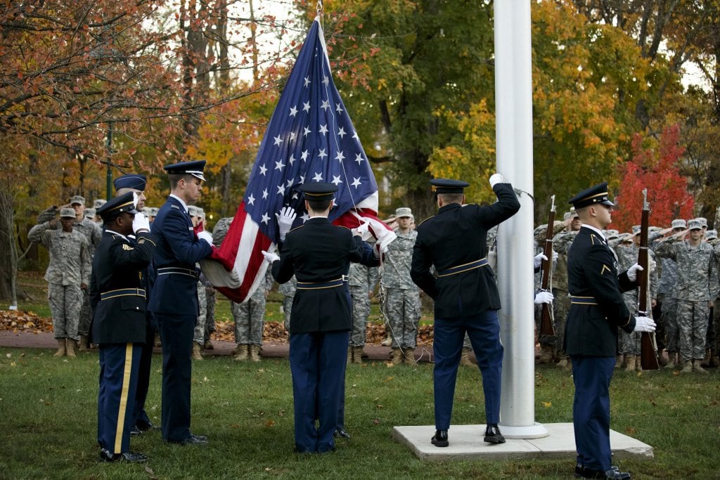 A joint cadet color guard raises the flag during a Veteran's Day ceremony outside of Franklin Hall at Indiana University Bloomington on Friday, Nov. 11, 2016.